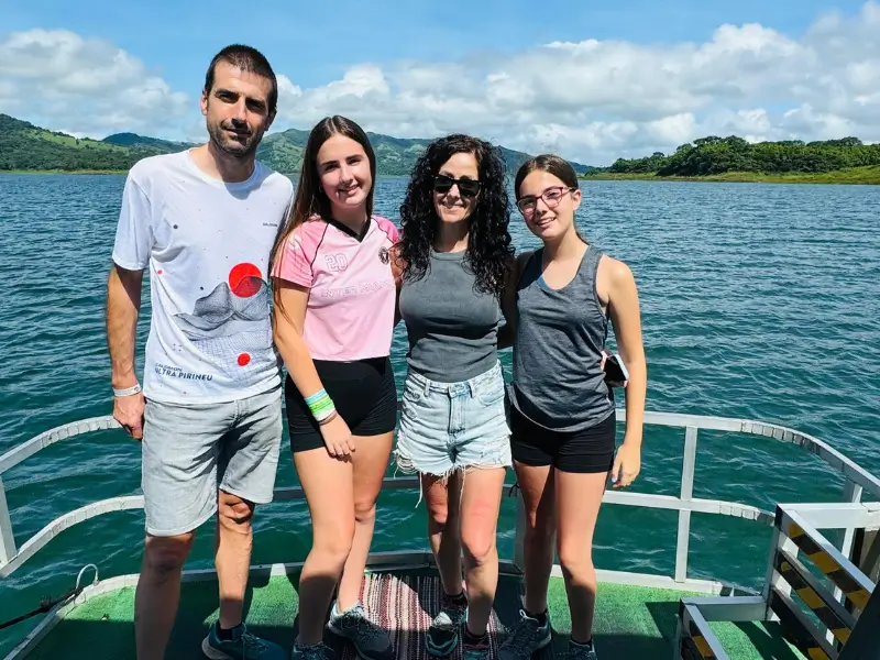 A family enjoying a scenic boat ride on Arenal Lake in Costa Rica.
