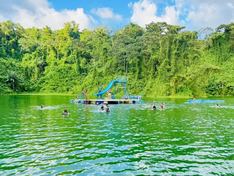Kids playing on the floating platform at Arenal Lake, Costa Rica.