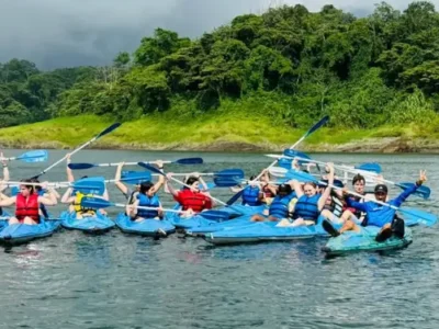 A family kayaking on Arenal Lake with stunning volcanic views.