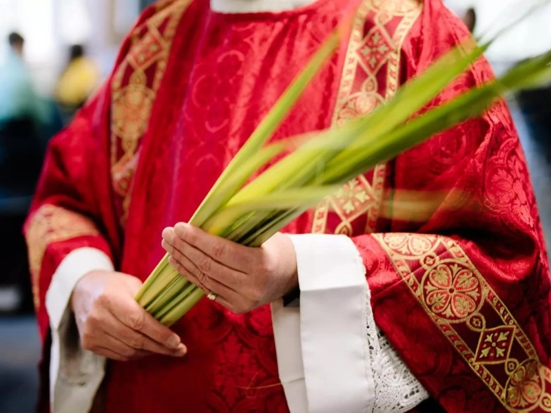 Catholic Priest at Holy Week procession with palms in Costa Rica